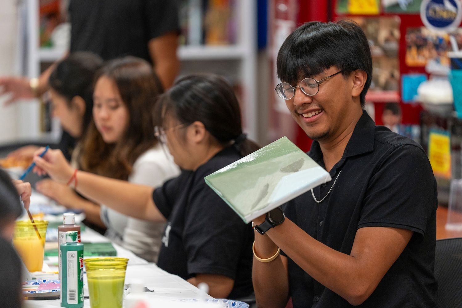 Smiling while painting an art piece