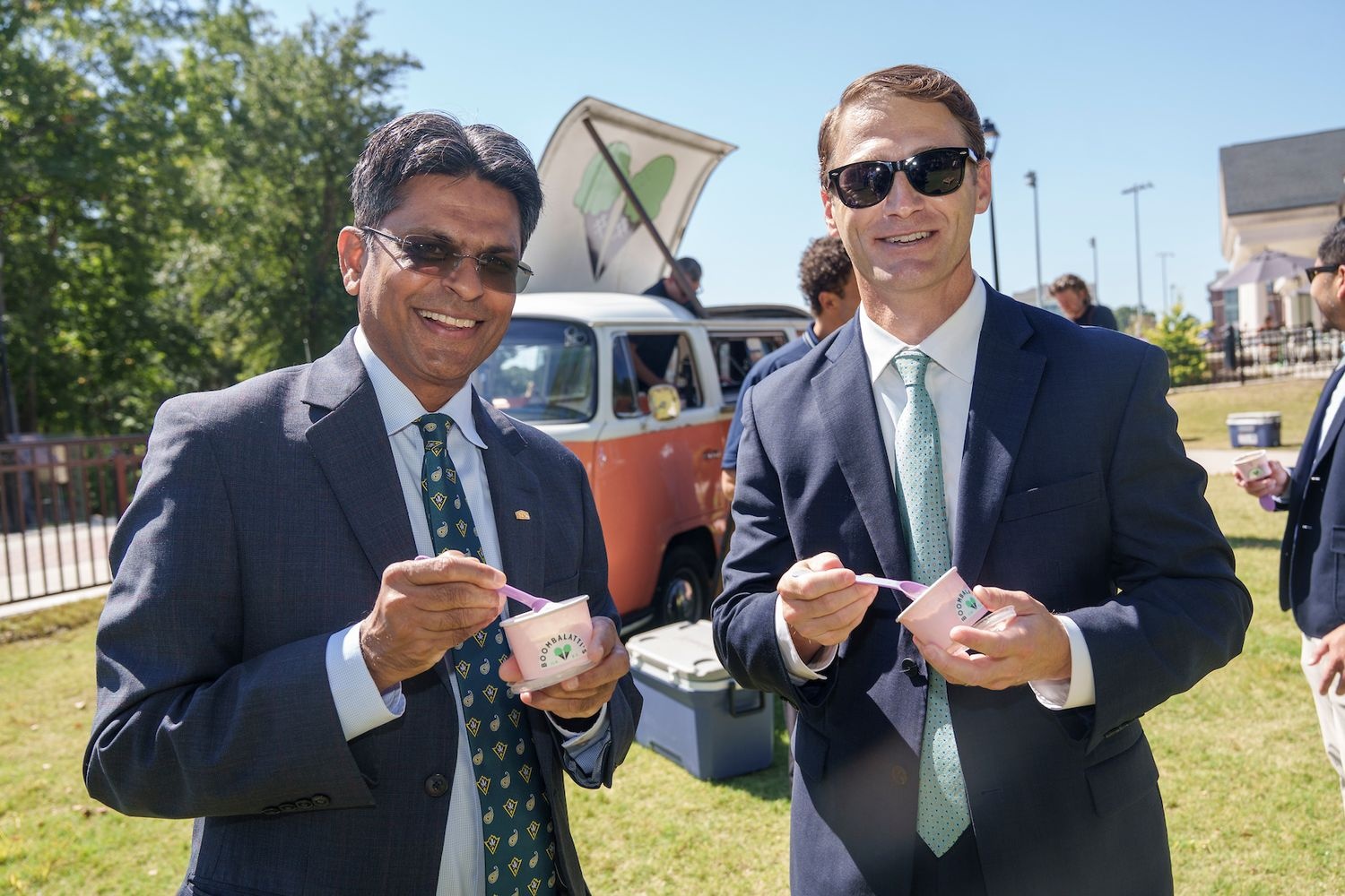 Chancellor Volety eats ice cream outside Boombalatti's opening on campus