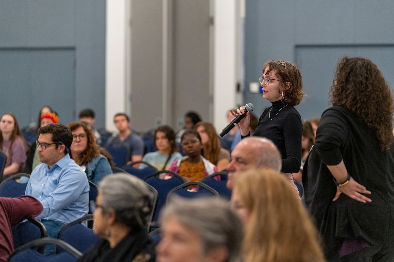 Woman asking question at a keynote lecture