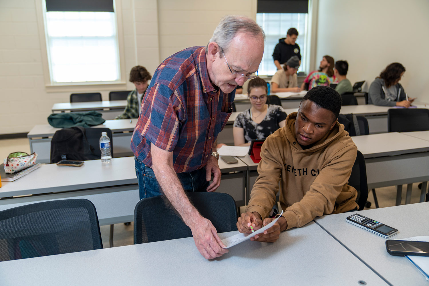 faculty member helps student with math problem