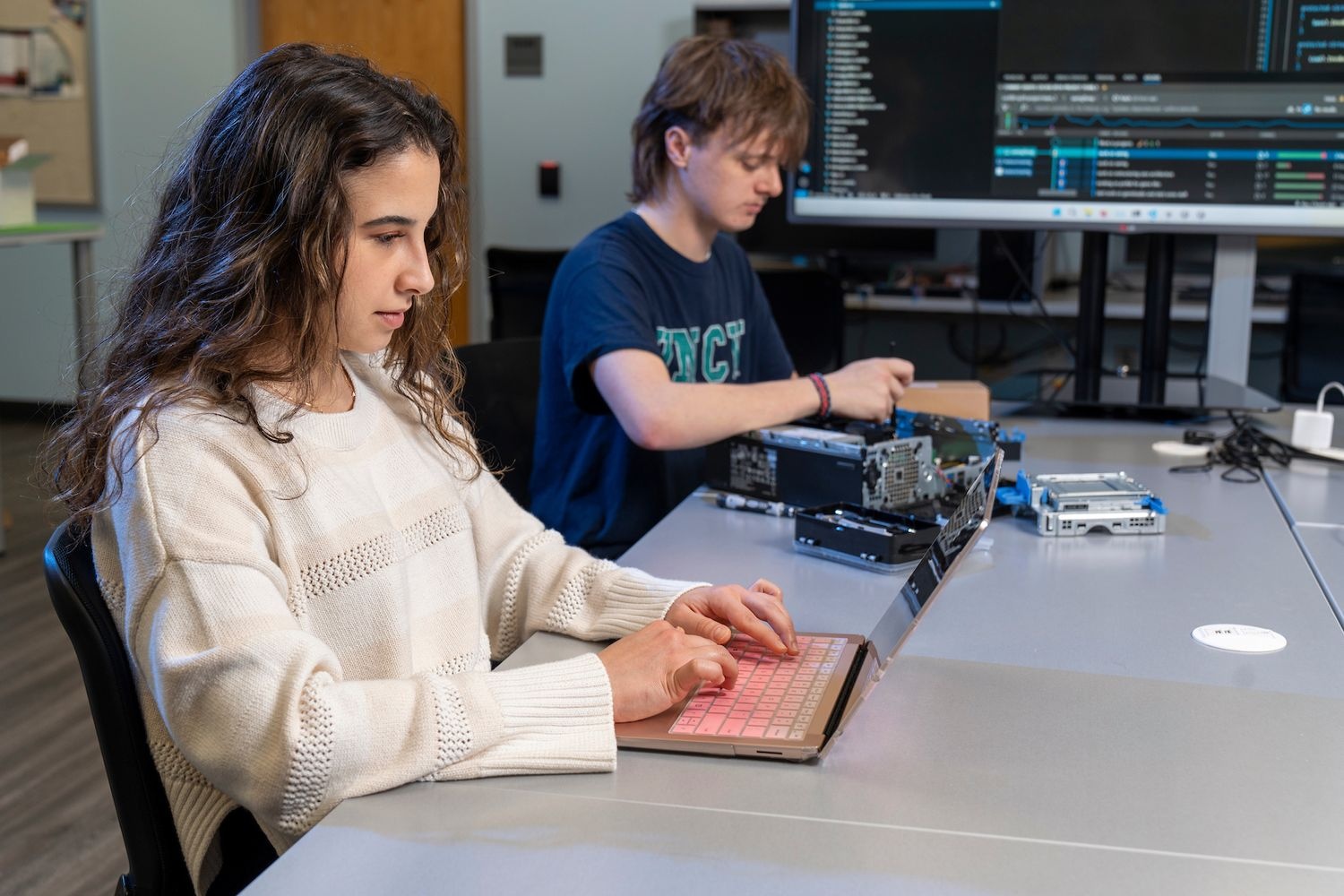 Computer science students working on laptops