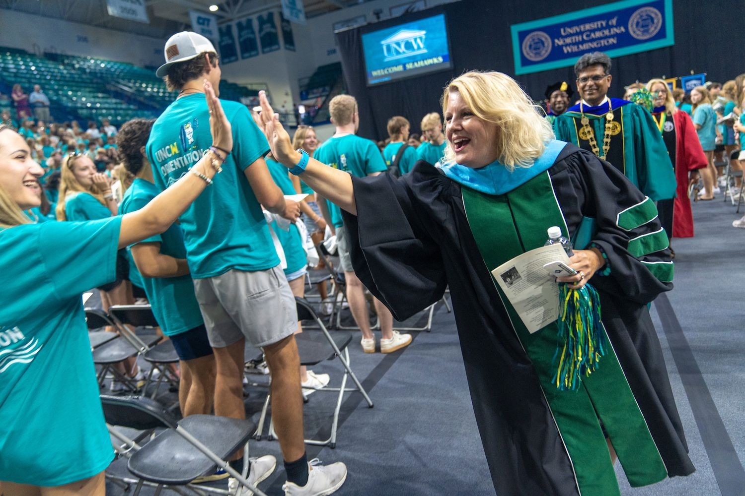 Administrator high fiving student