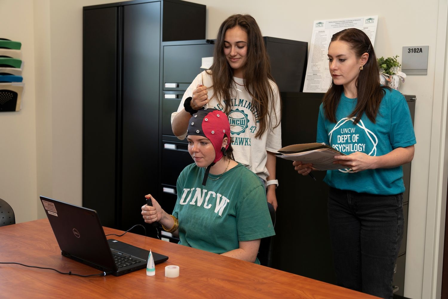 students under the direction of Professor Dr. Kate Nooner collect EEG and MRI readings. 