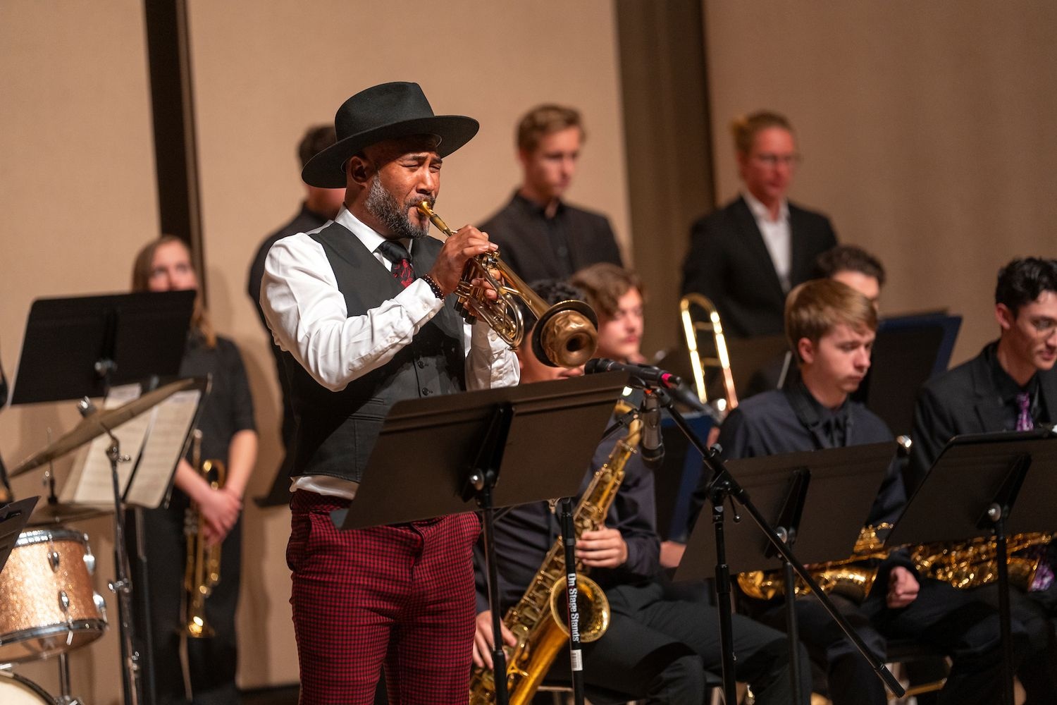 Performer playing trumpet on stage