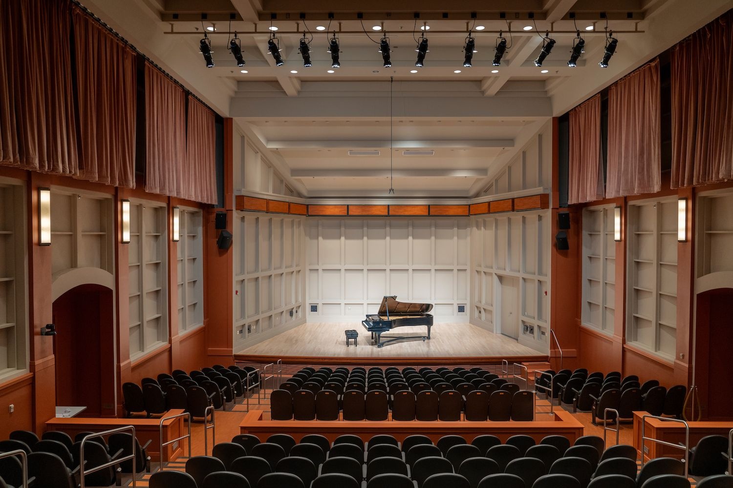 An empty stage with a piano on it