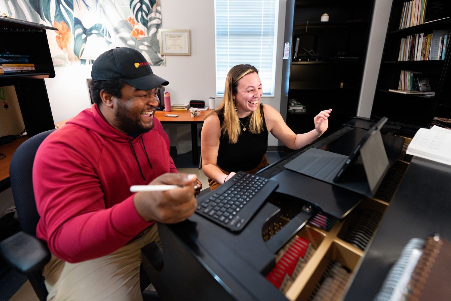 Professor and student working on a laptop