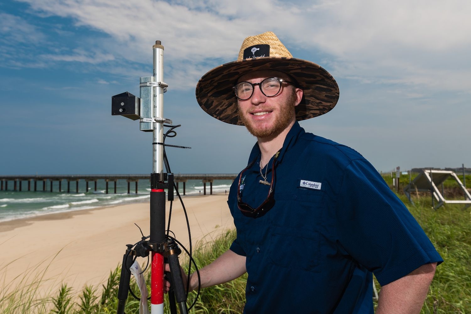 Student setting up LiDAR technology on the beach