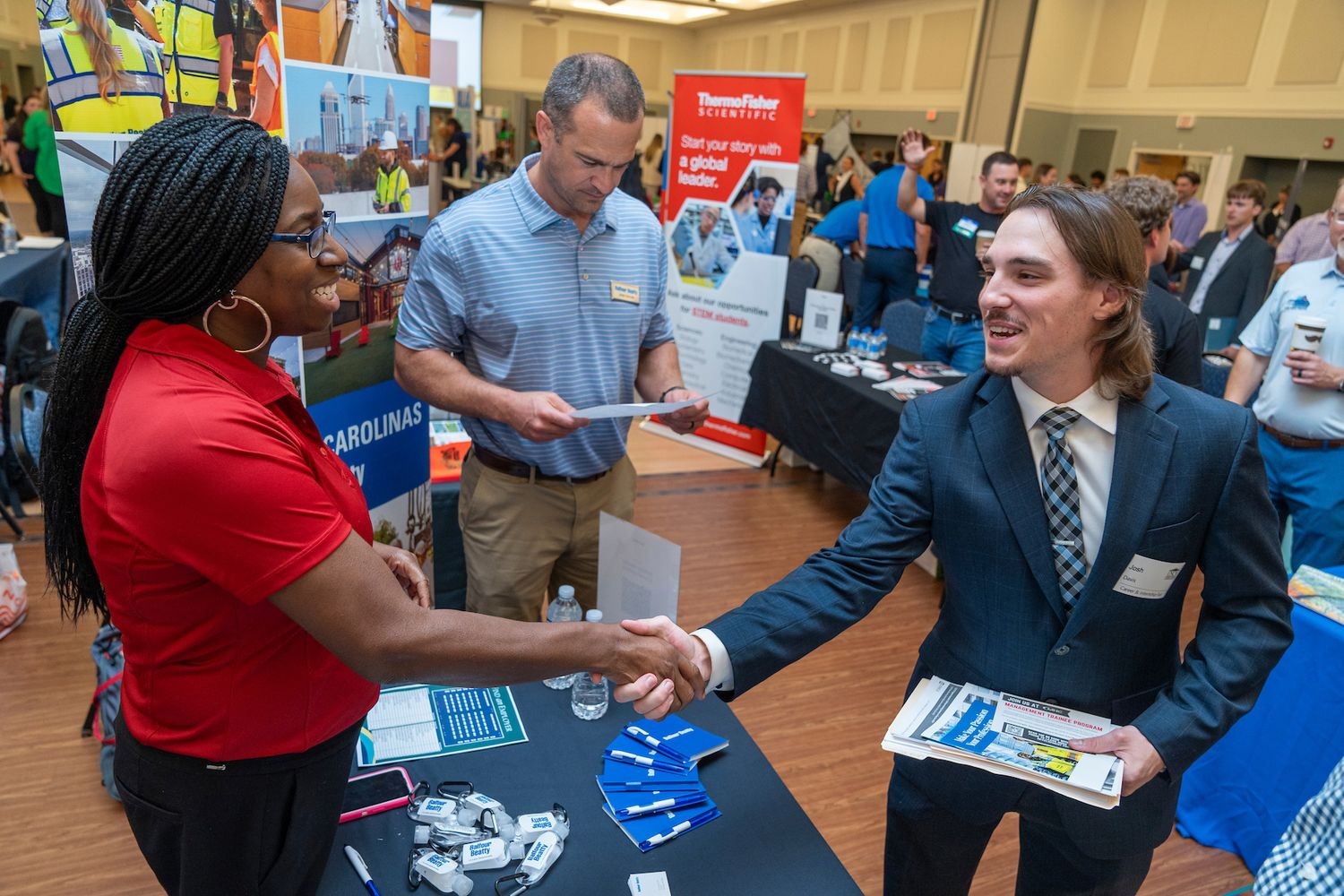 Student shakes hand of potential employer at Fall 2024 Career and Internship Fair
