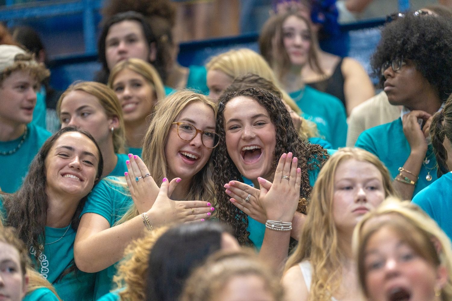 Students in crowd throwing seahawk handsigns