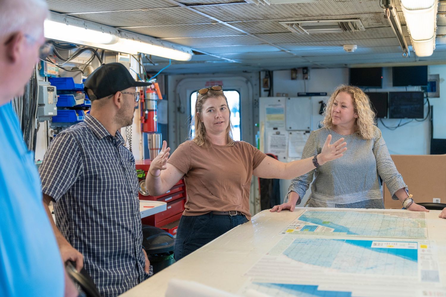 Shipmates discussing plans with maps