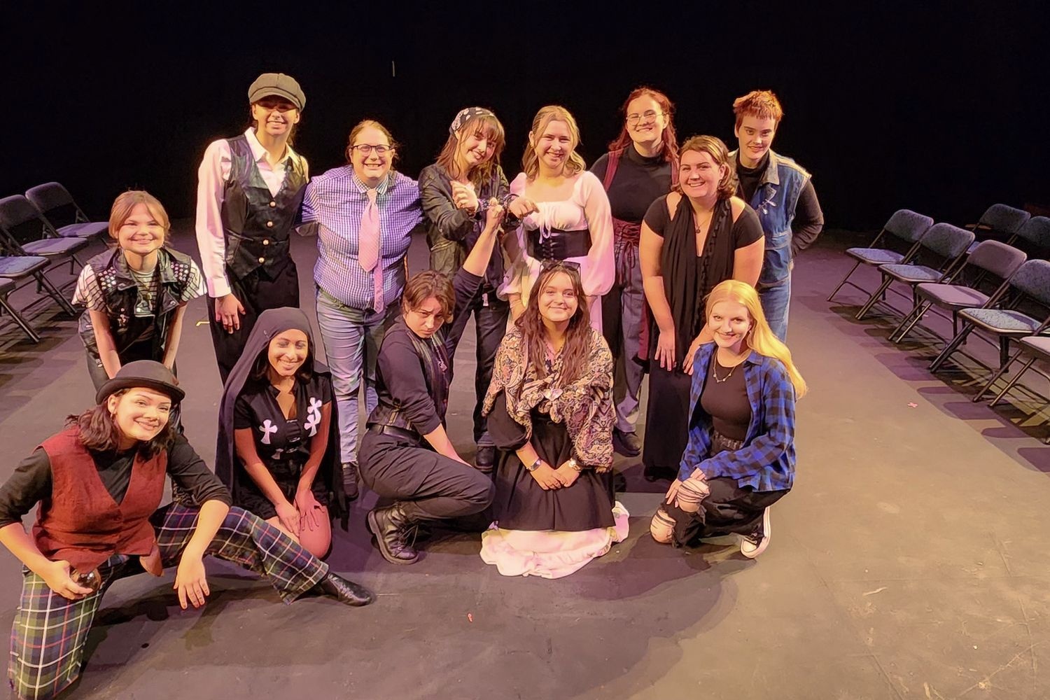 The cast of Riot Grrls: Measure for Measure pose at the black box theater on campus