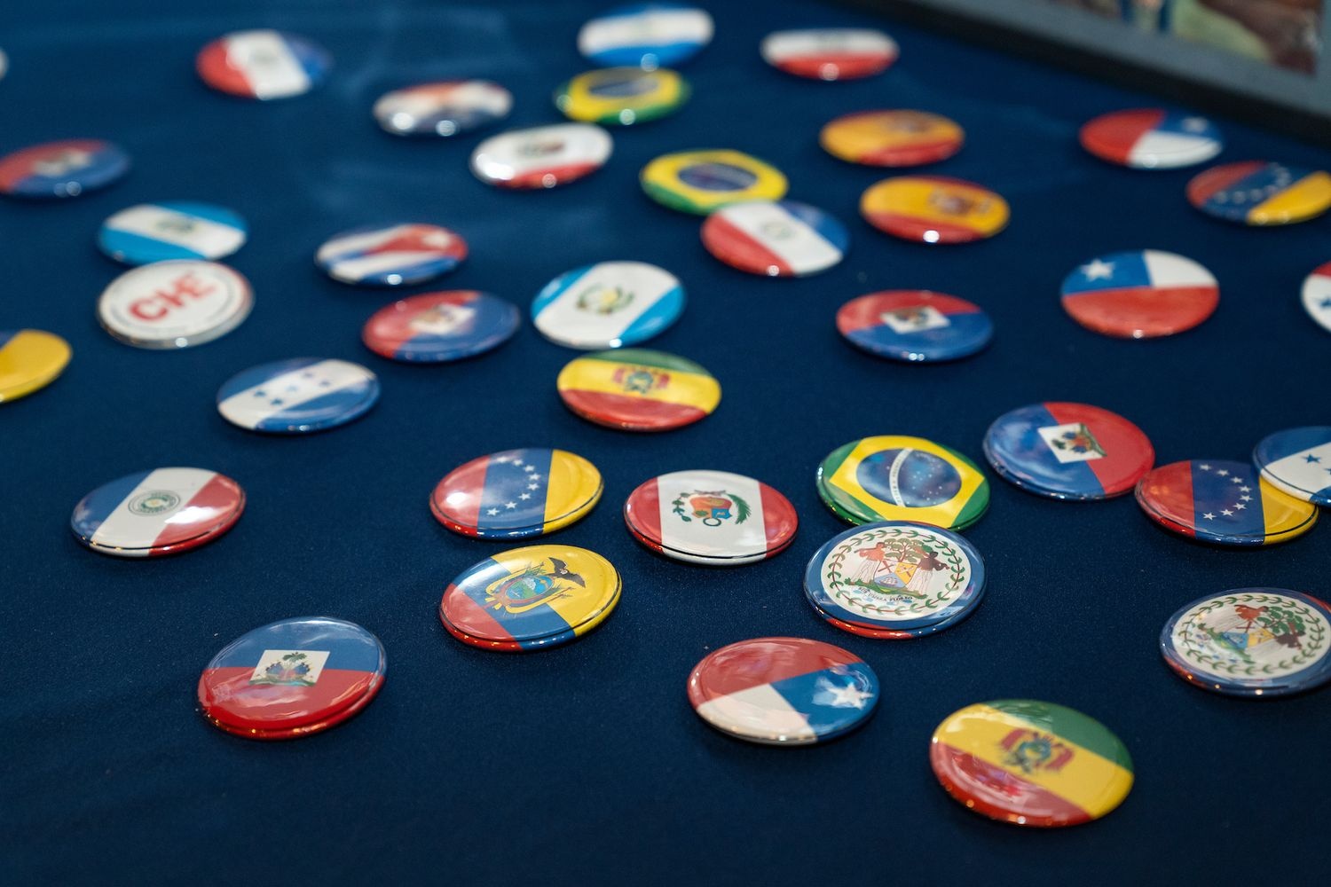 Pins of different countries flags laying on a table