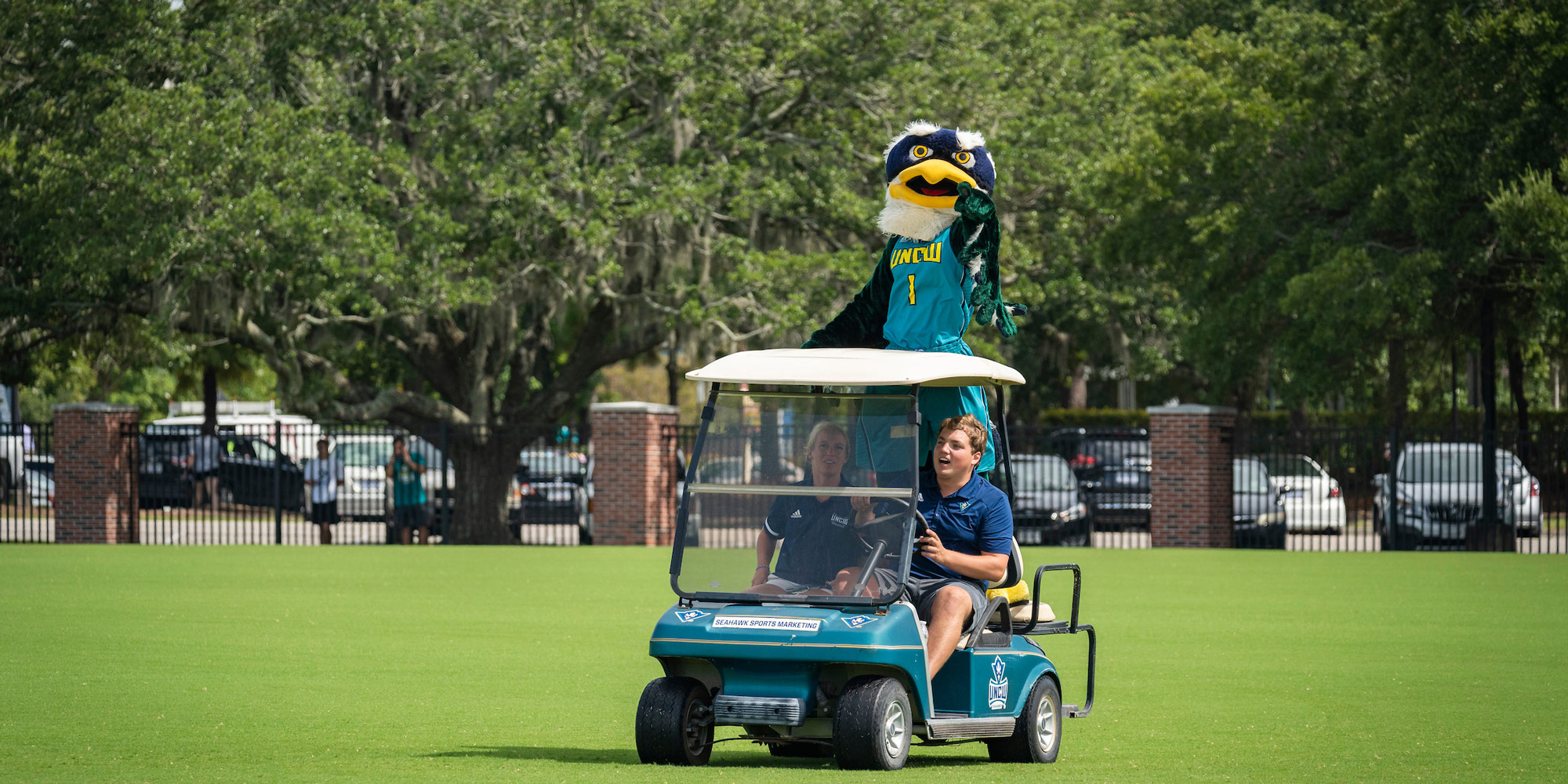 Our Mascot Sammy Seahawk rides in a Golf cart