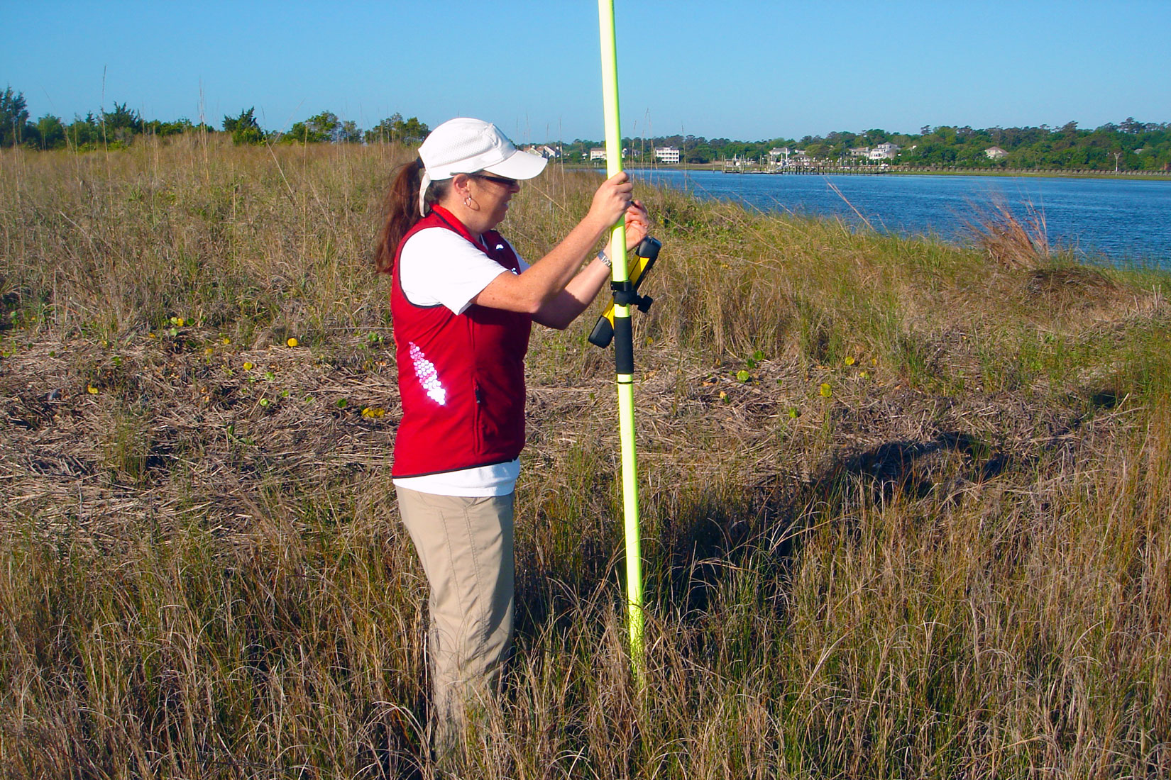 UNCW Professor Joanne Halls uses Global Positioning Systems (GPS) to create map boundaries for different wetland species as well as upland habitats on Masonboro Island, a coastal site within the National Estuarine Research Reserve System (NERRS). NERRS is a network of 30 coastal sites designated to protect and study estuarine systems.