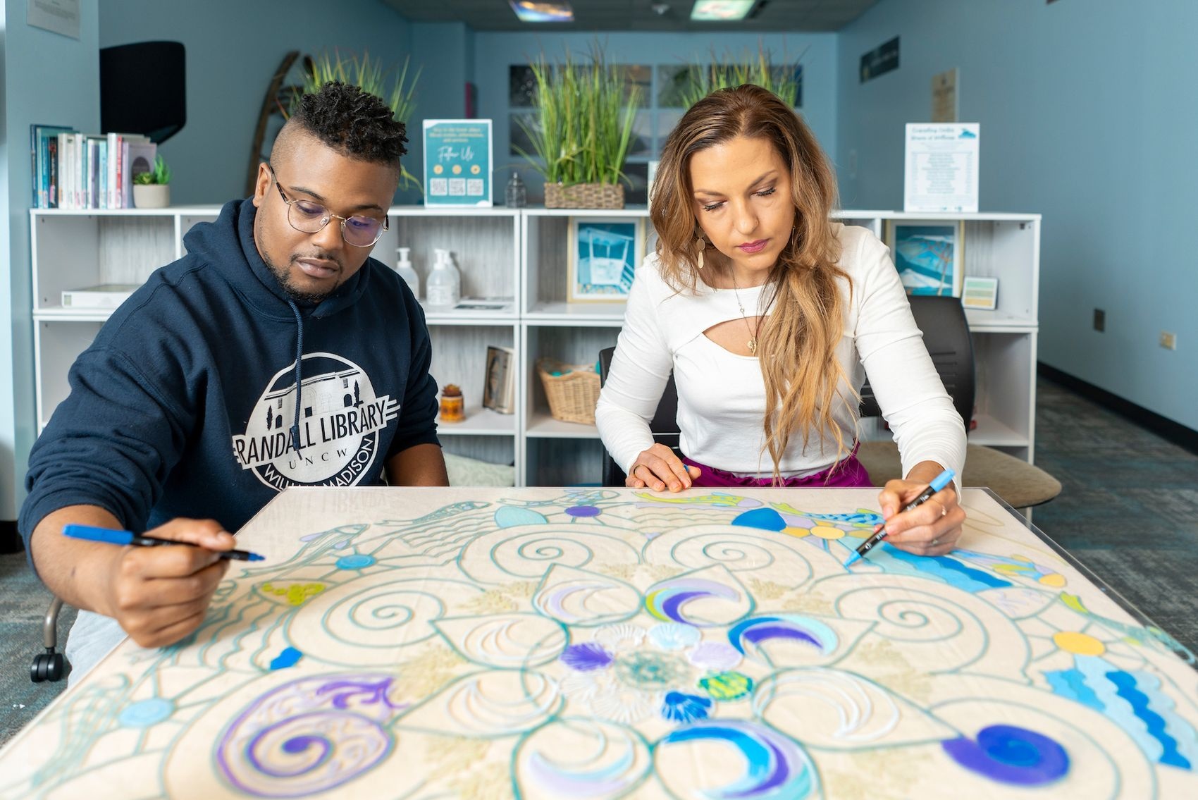 Christopher Robinson and  Gina Marie Jasionowski work on a mandala art project in Randall Library.
