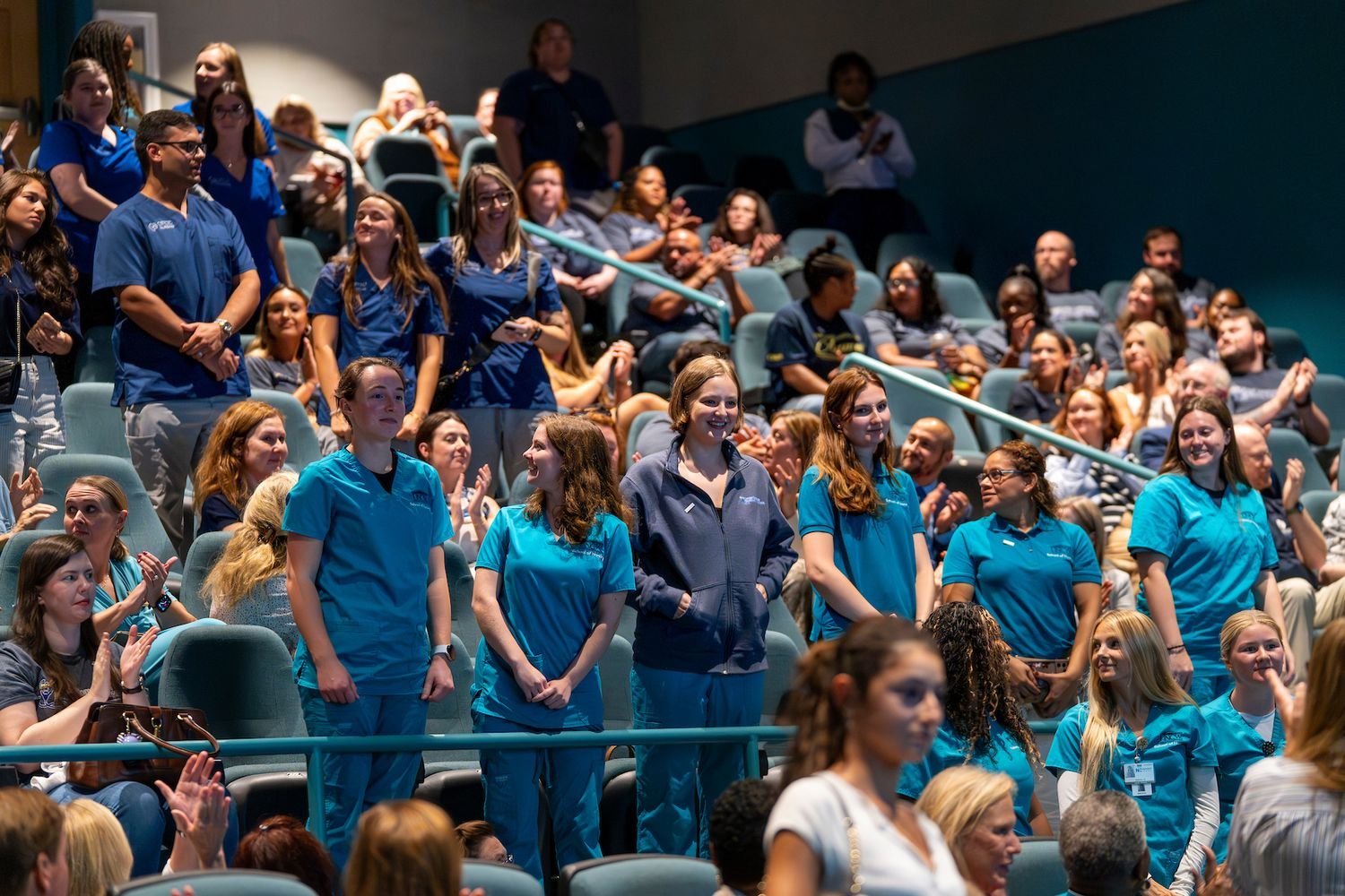 UNCW nursing students standing during a community forum on healthcare workforce