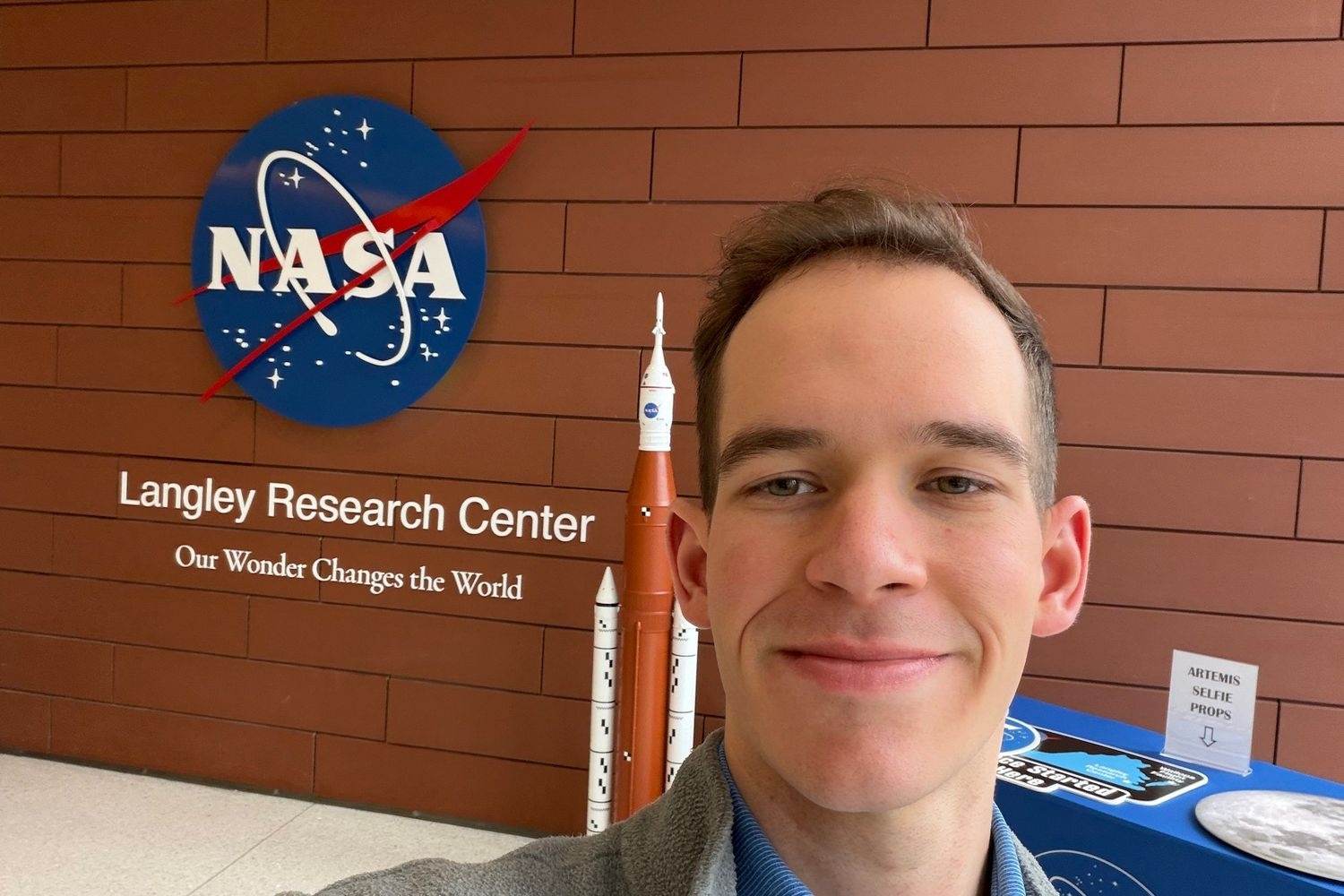 Luke Butler stands in front of the NASA Langley Research Center sign