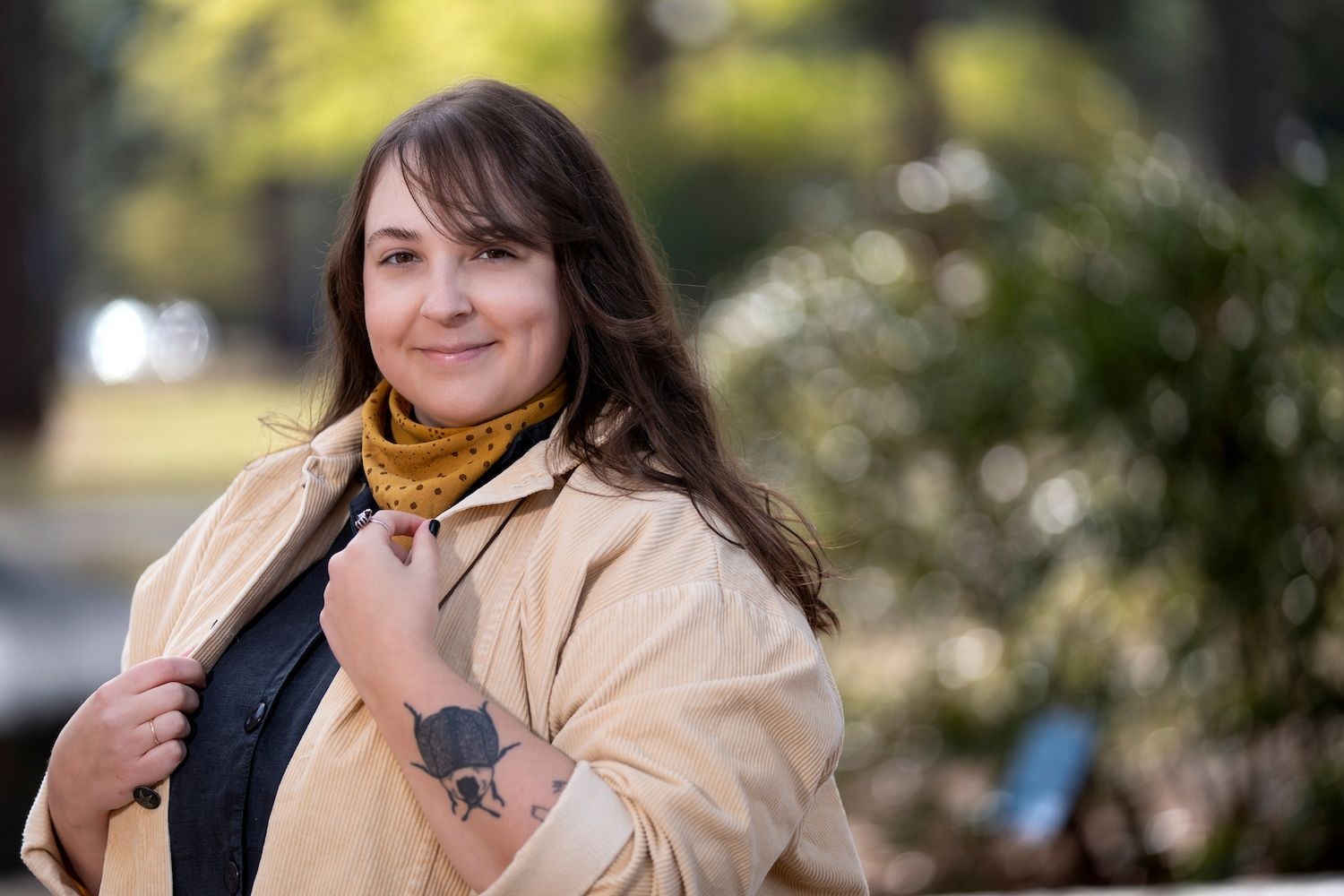 UNCW student sitting outside on campus