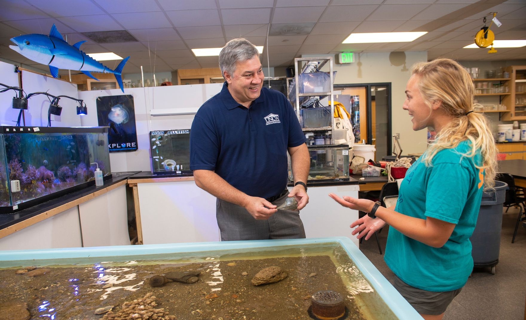 Teacher talks to student over a touchtank