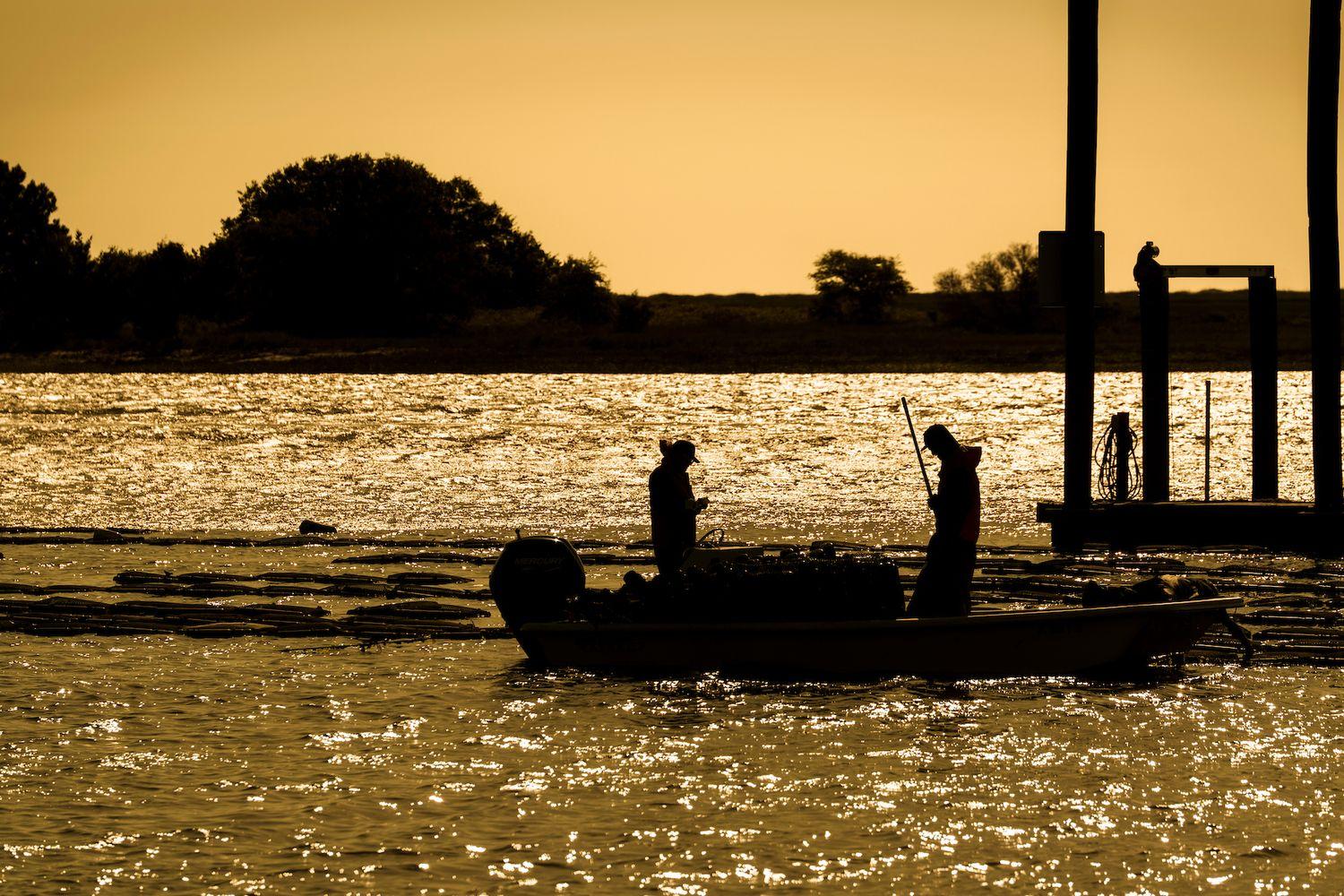 Two people on a boat in low light