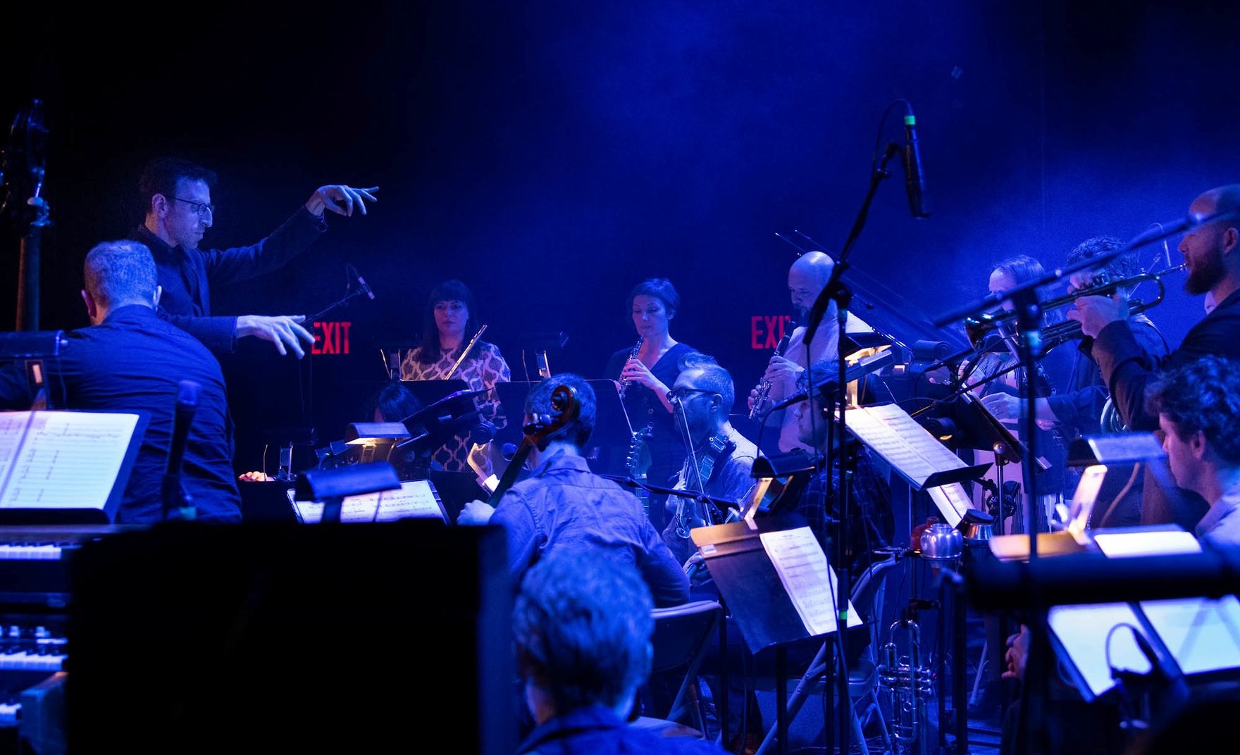 Conductor leading a band in performance