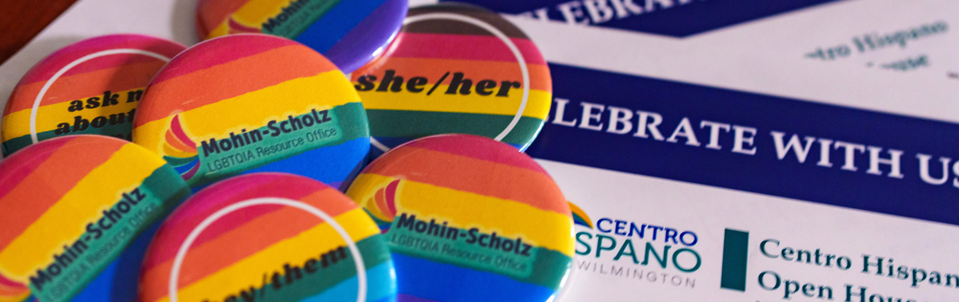 Rainbow buttons on a table with pronouns