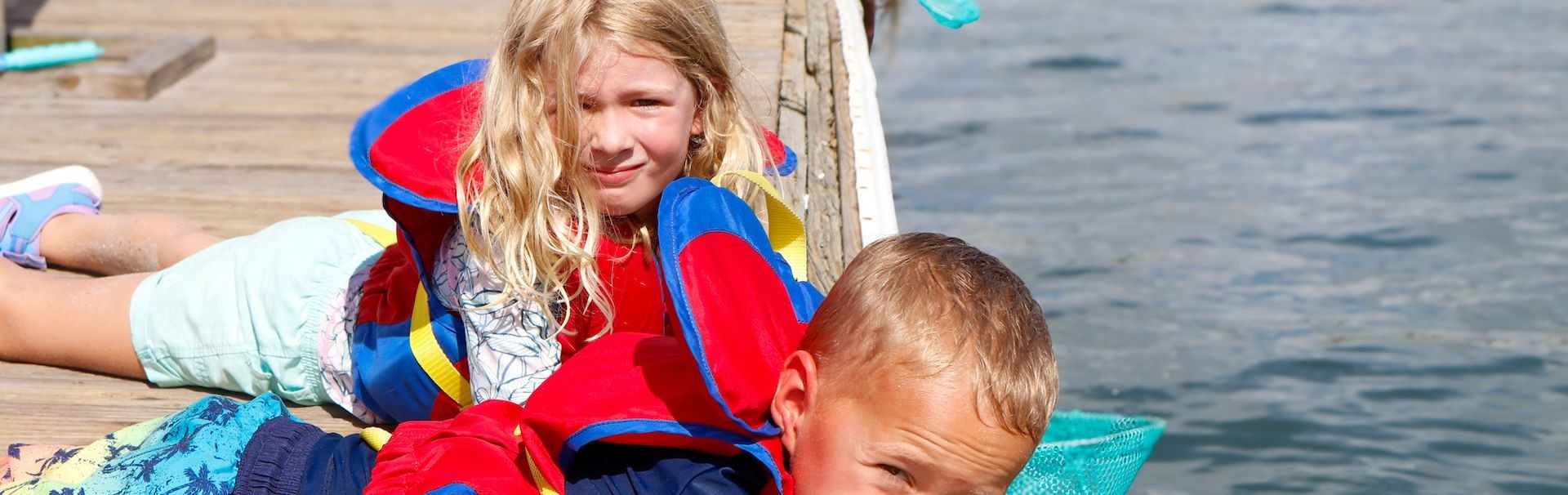 2 youth in lifevests on pier