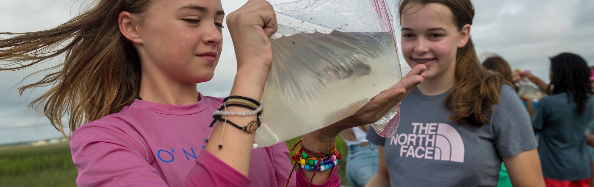 Campers holding fish in a bag
