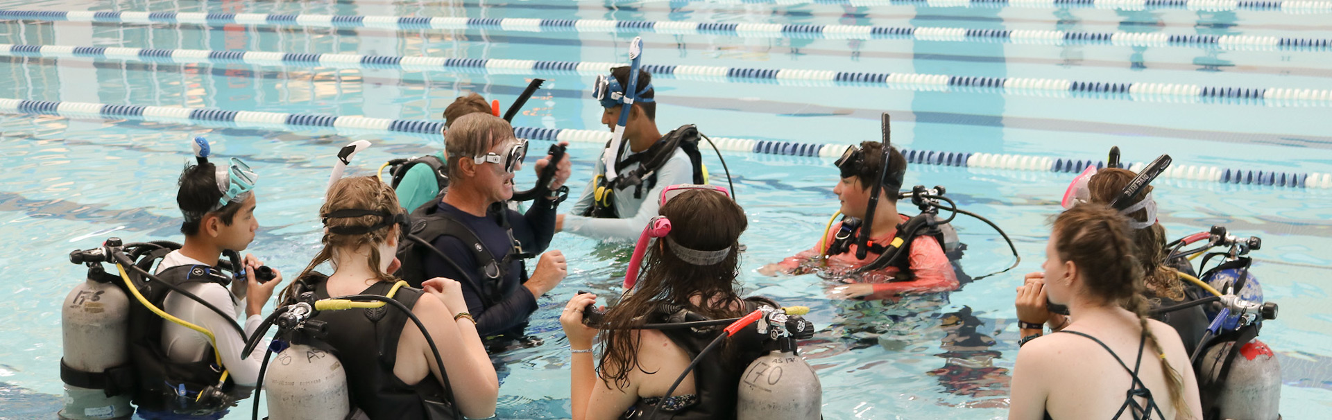 Scuba class wearing scuba gear in pool