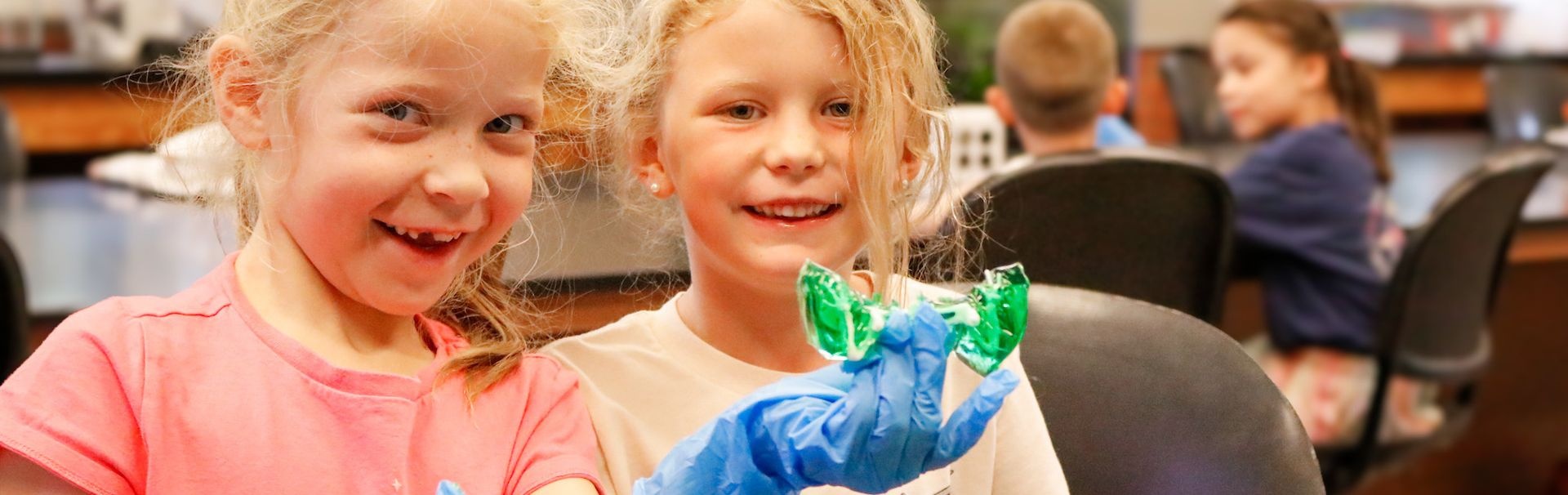 Sea safari campers wearing gloves to show off their experiments