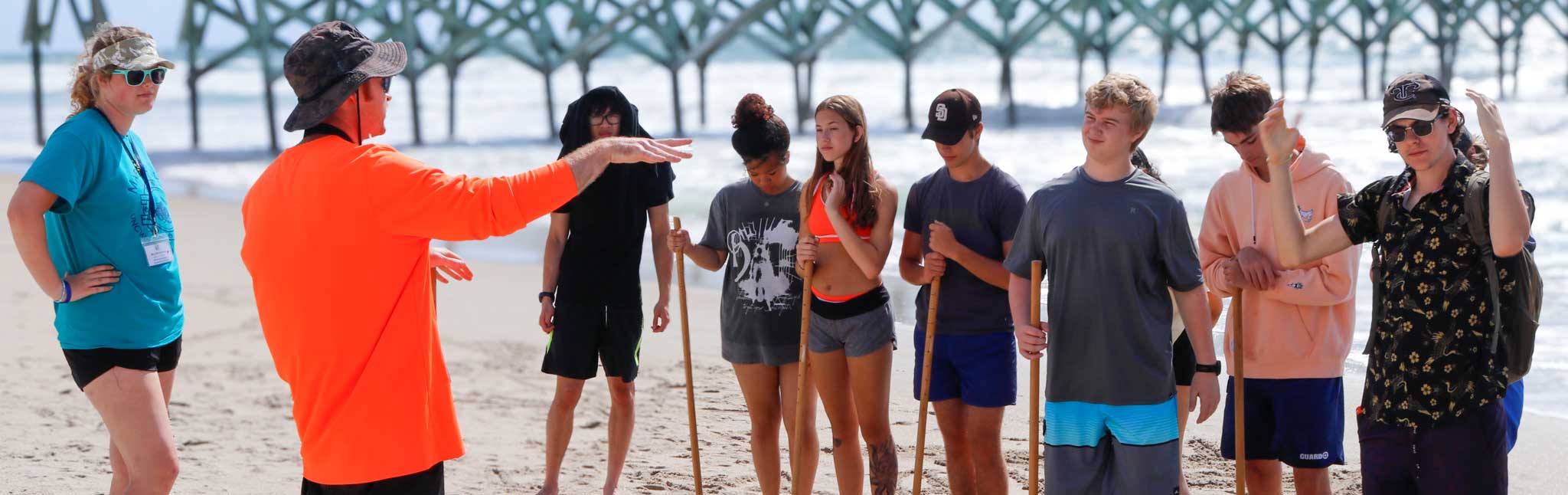 Students on the beach with instructors