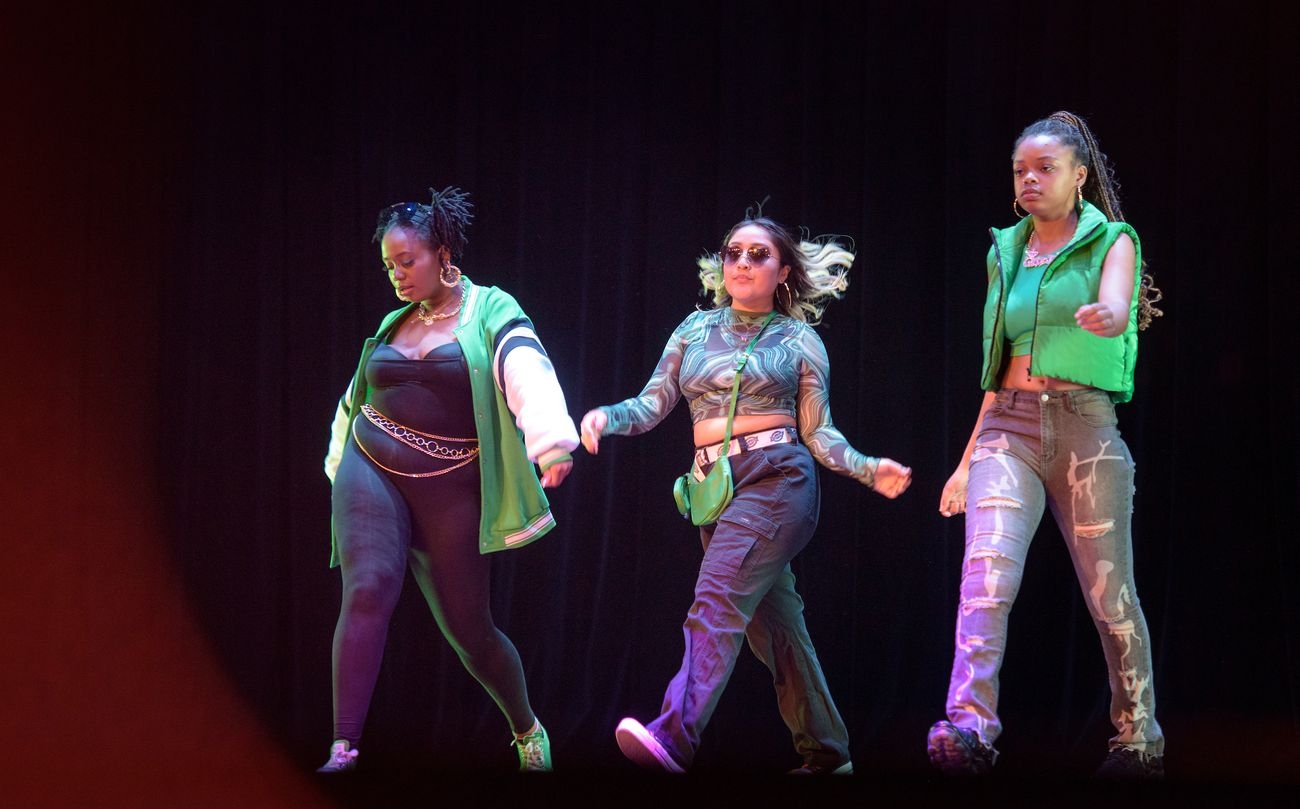 Students posing and walking on catwalk for fashion show