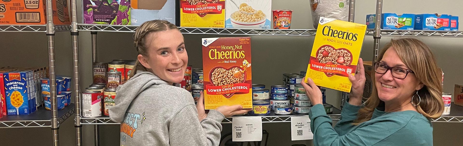 Volunteers holding Cheerios in the pantry