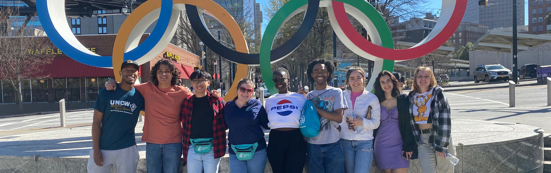 Students standing in front of the Olympic Rings