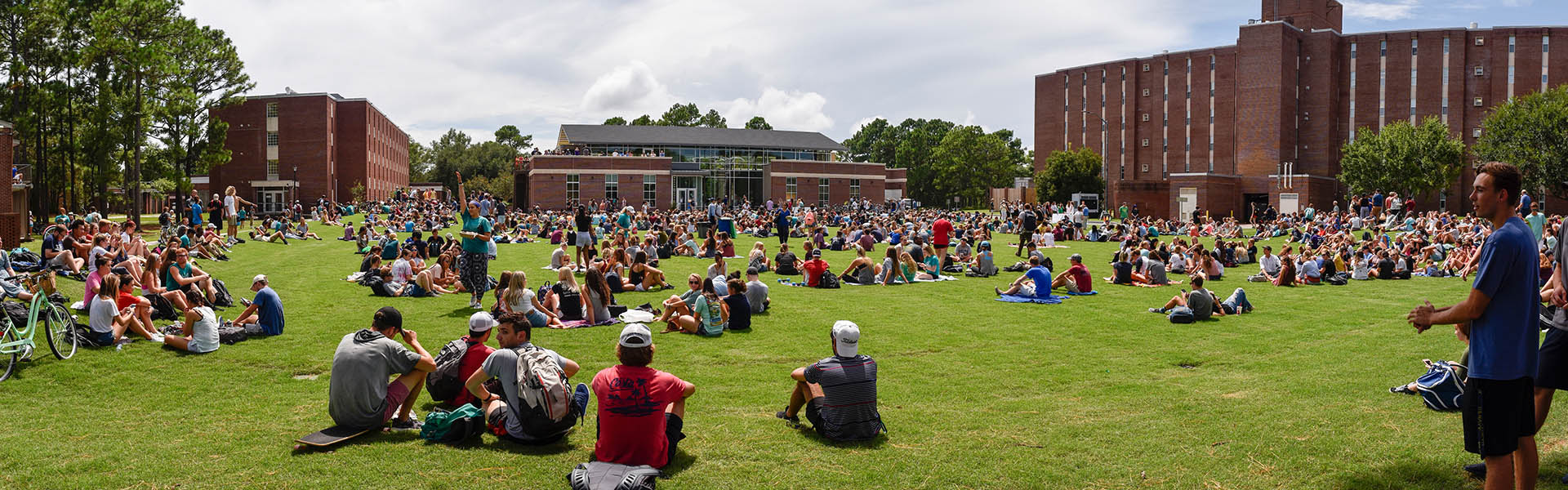 students sitting on the lawn