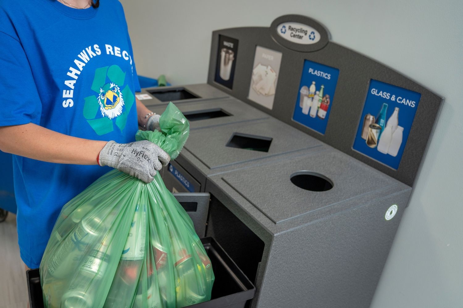 Recycling center with bag of recycling being removed