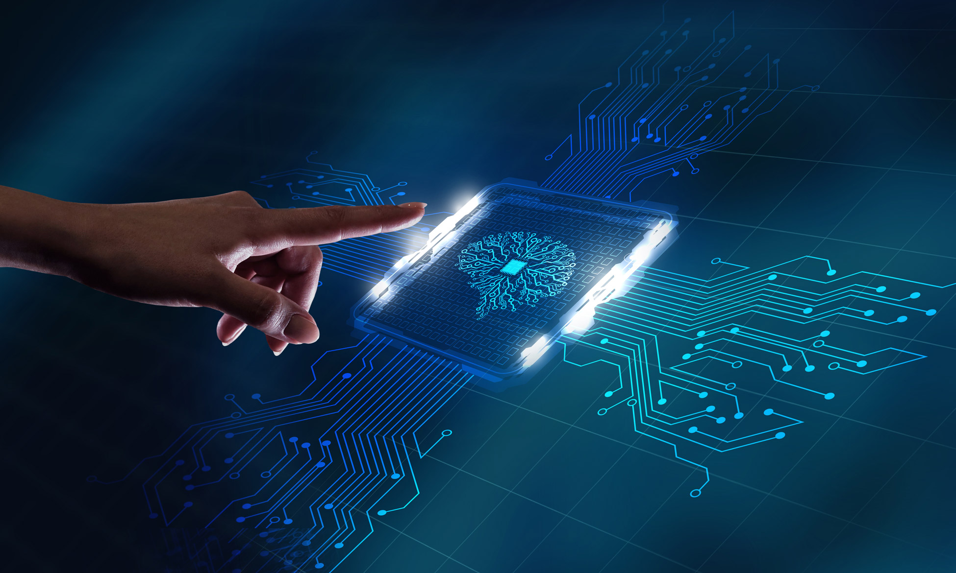 hand pointing to a computer chip