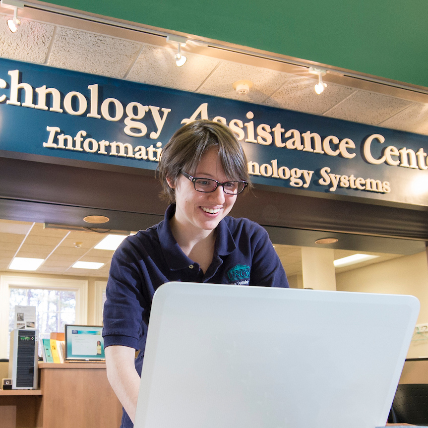 Technology Assistance Center (TAC) employee works on a computer