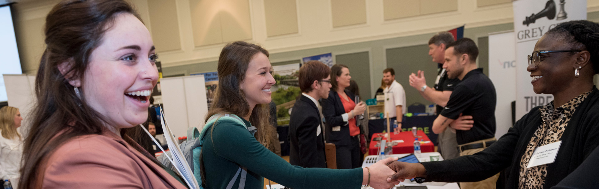  A young woman shakes hands with a prospective employer at the Job and Internship Fair